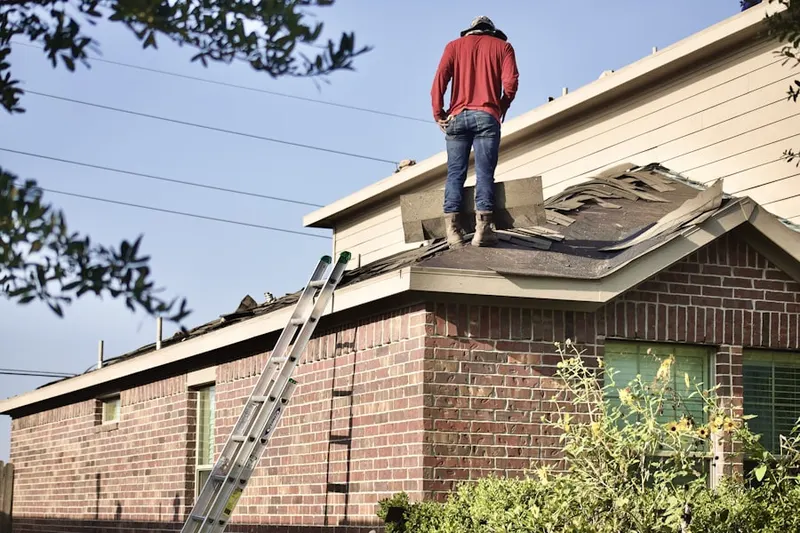 Professional roofer working on a residential roof in Spyglass Estates